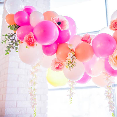 Pink Balloon Arch Decorated With Fake Flowers & Leaves